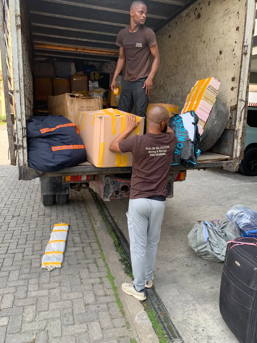 Mover carrying a packed box down a staircase