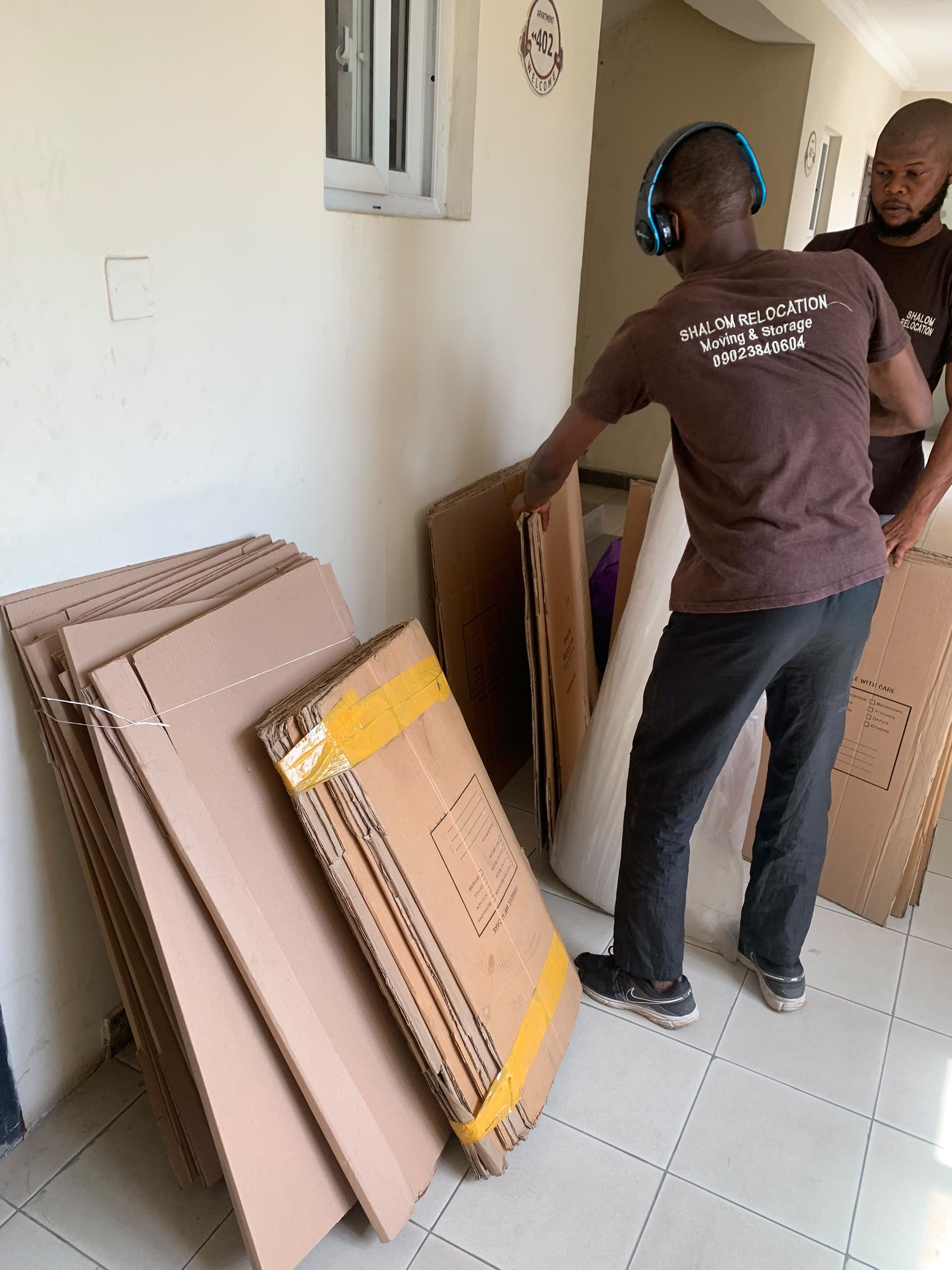 The team preparing furniture panels and protective packaging inside a home.