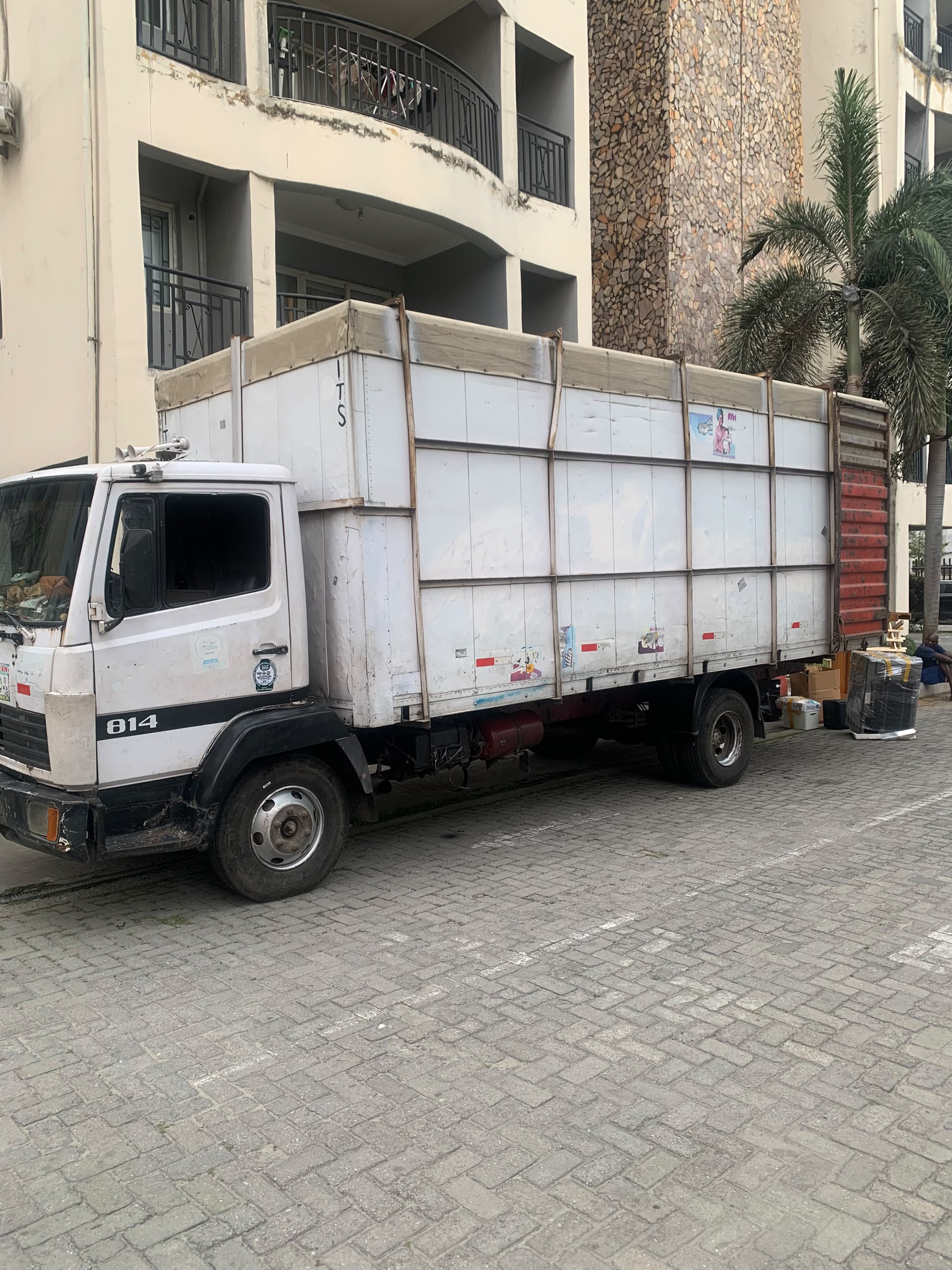 A moving truck parked outside a residential building.